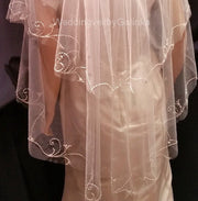 The wedding veil is embroidered with a fishing line.