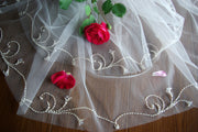 The wedding veil is embroidered with a fishing line.