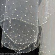 Wedding veil with pendants.  The veil embroidered with beads