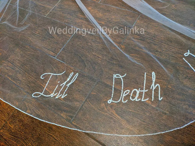 Wedding veil with phrases, words, letters embroidered with beads.