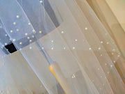 Wedding veil with a scattering pearls. Edging zigzag.