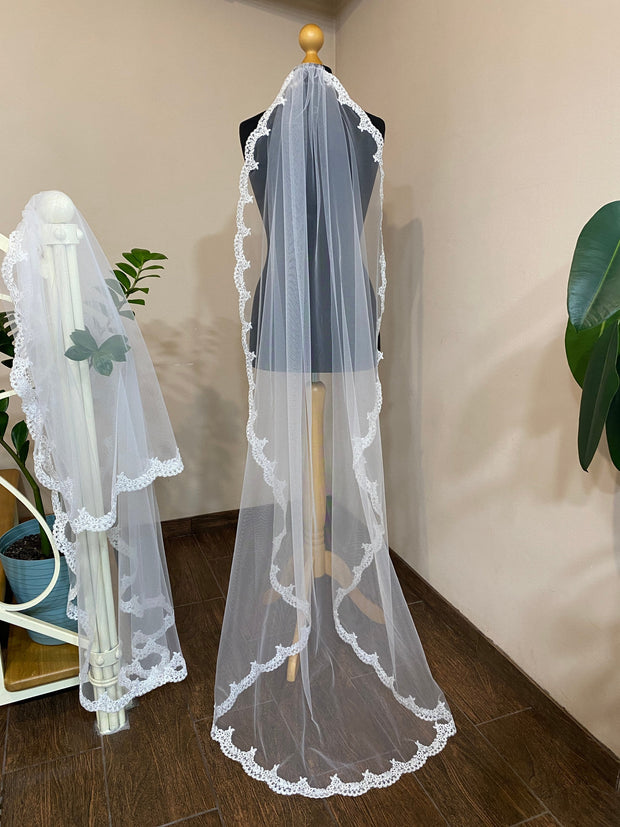 Lace wedding veil for the bride fixed on a comb.