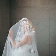 Wedding veil with a wreath and scattering flowers