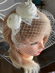 Hat veil on the headband decorated with roses and rhinestones.